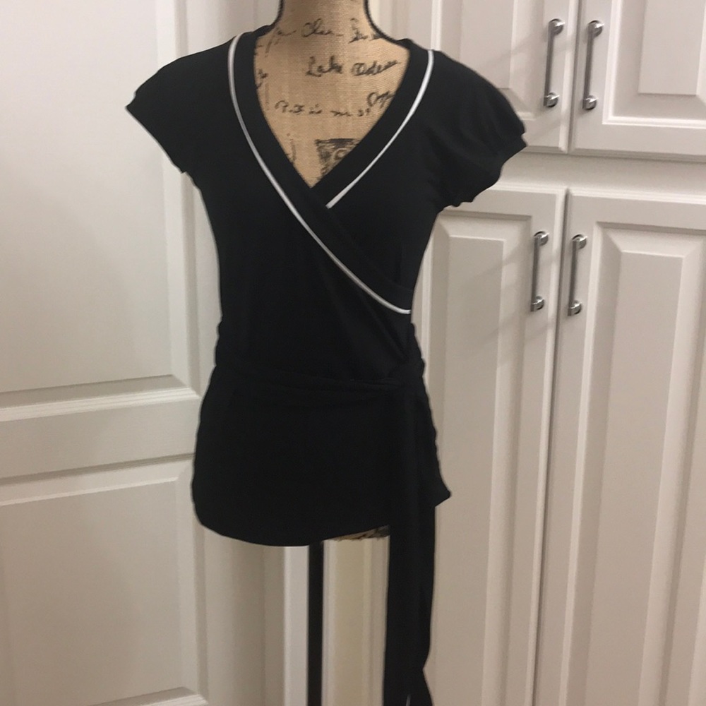 Black shirt with white piping.